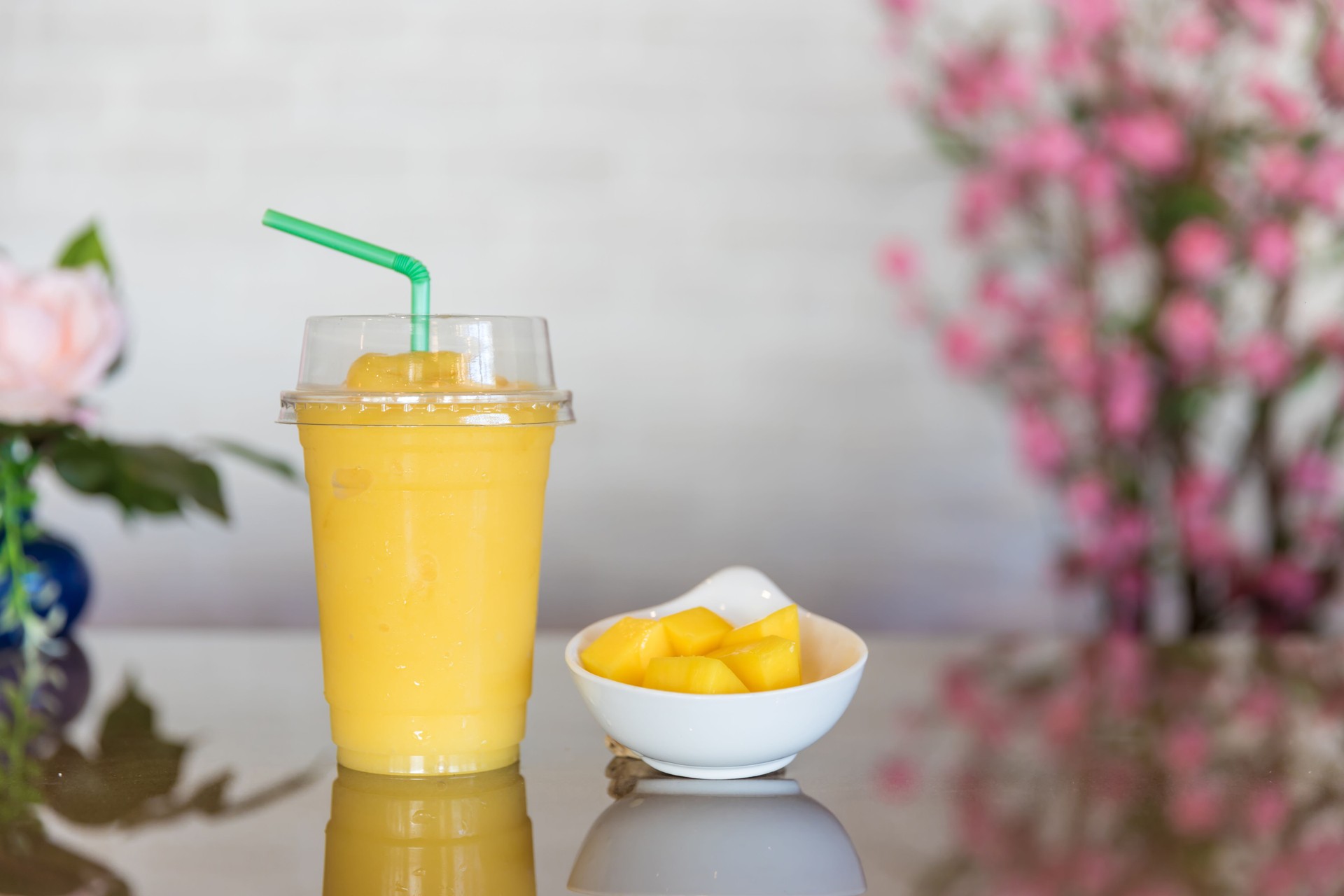 Mango smoothie in a glass. Mango shake. Tropical fruit concept. Refreshing and healthy mango smoothie in glass. Mango shake. Fresh tropical fruit smoothies