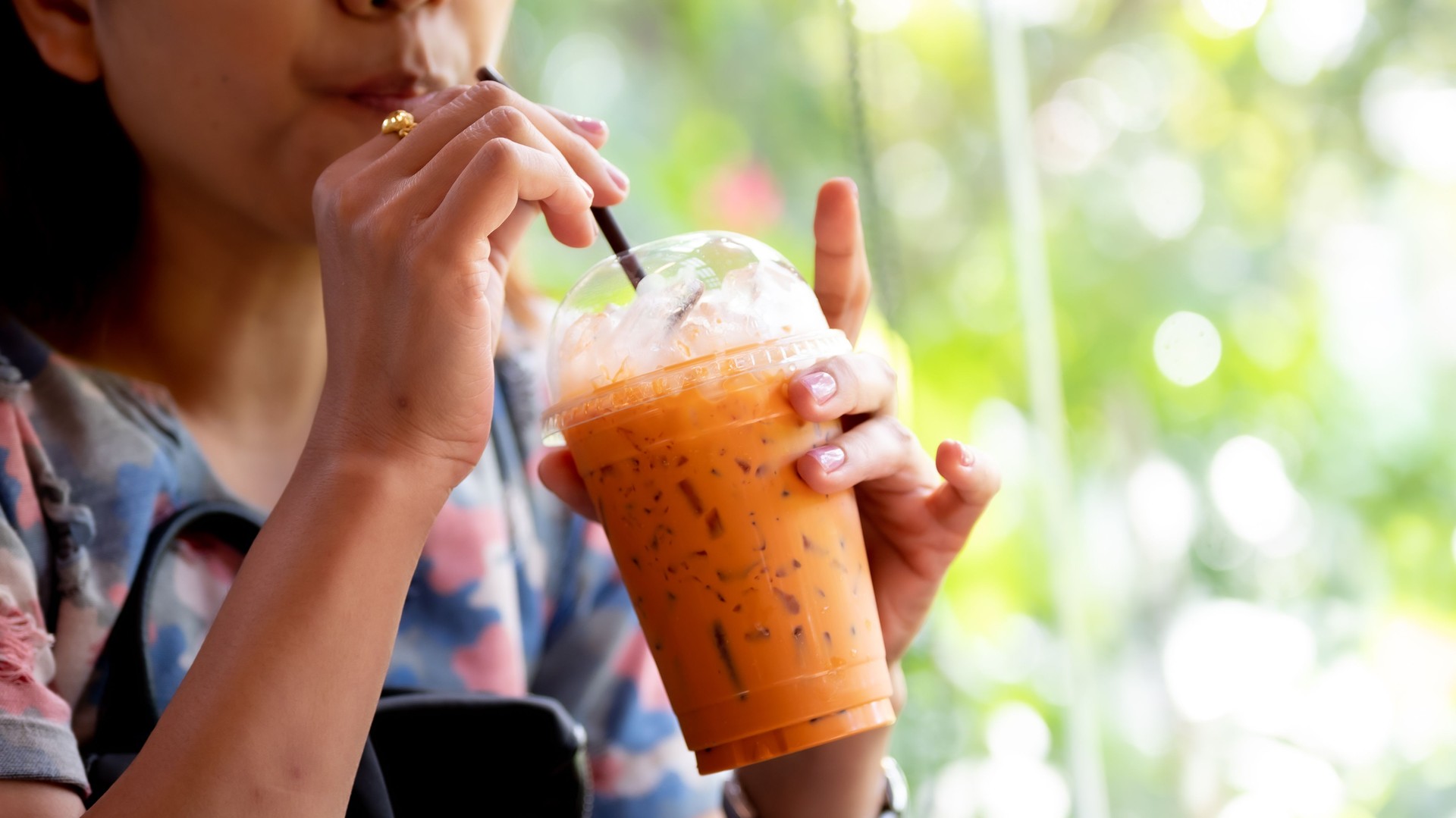 Woman drinking ice coffee in the cafe